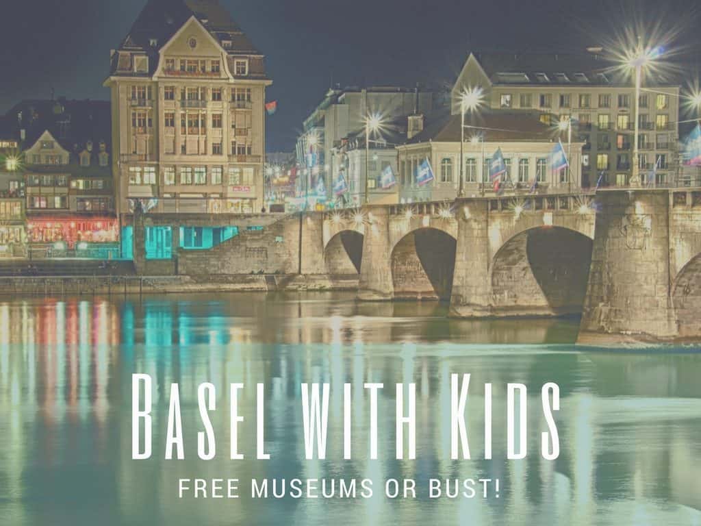 Image Basel waterfront & river at night with text overlay, " Basel with Kids: Free Museums or Bust!"