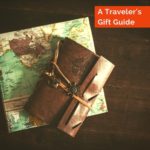 image of a travel journal and map with text overlay A Traveler's Gift Guide