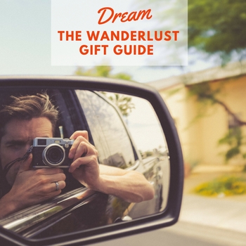 Image of person taking selfie in car mirror with text overlay Dream Wanderlust Gift Guide