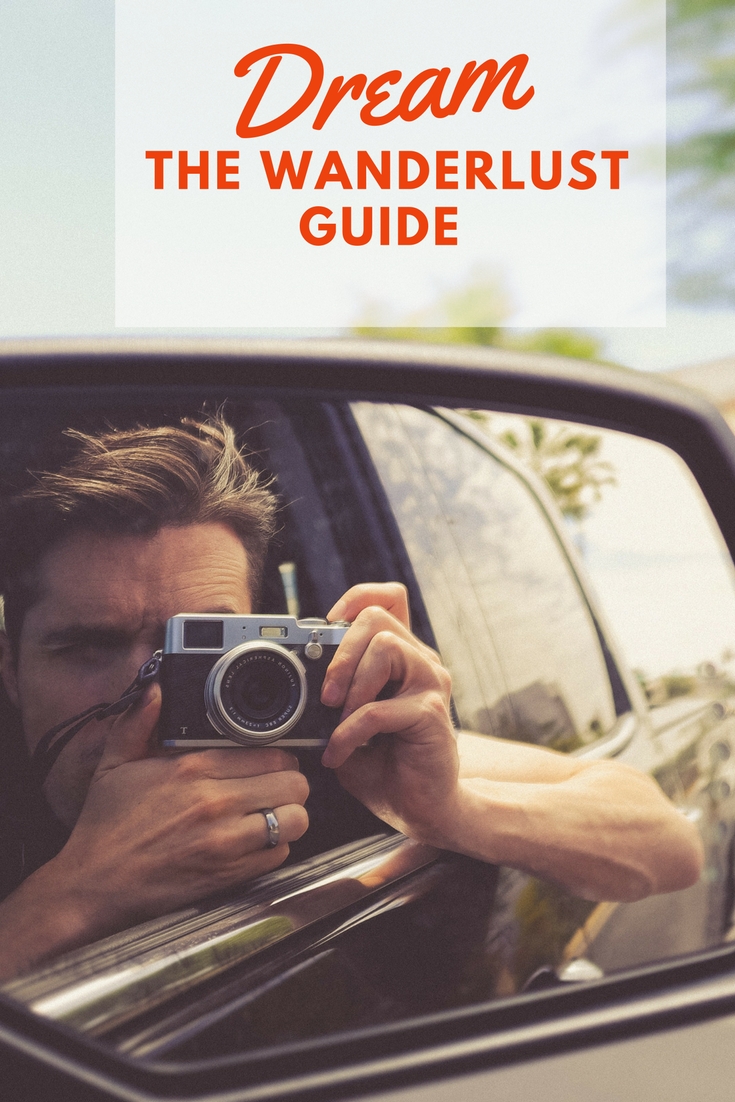 Image of person taking selfie in car mirror with text overlay Dream Wanderlust Gift Guide