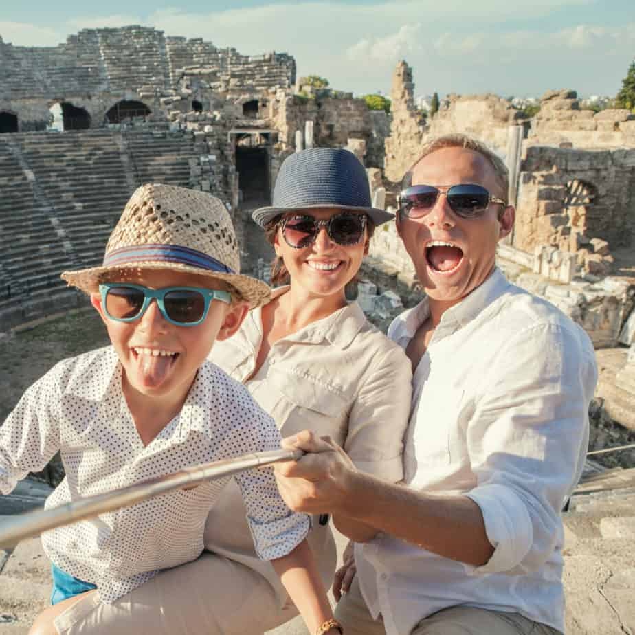 image of family taking selfie at the Roman Colosseum. Homeschool Travel Learn on www.CaptivatingCompass.com