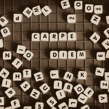 Image of letter tiles spelling out carpe diem with text overlay Con'ass Classroom's Visual Latin